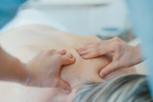 Beyond the Back: How Chiropractic Adjustments Benefit Your Entire Body person massaging the back of a woman